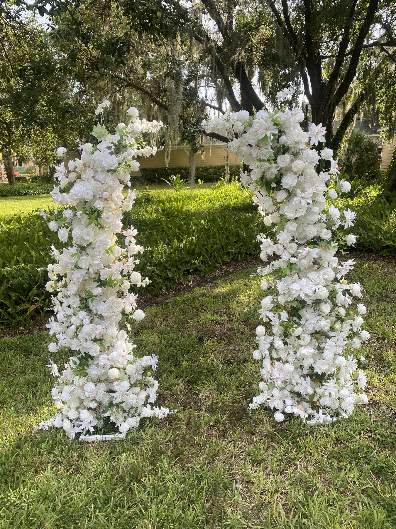Serenity twin floral arches standing in a garden, both arches fully in frame, Tampa Bay