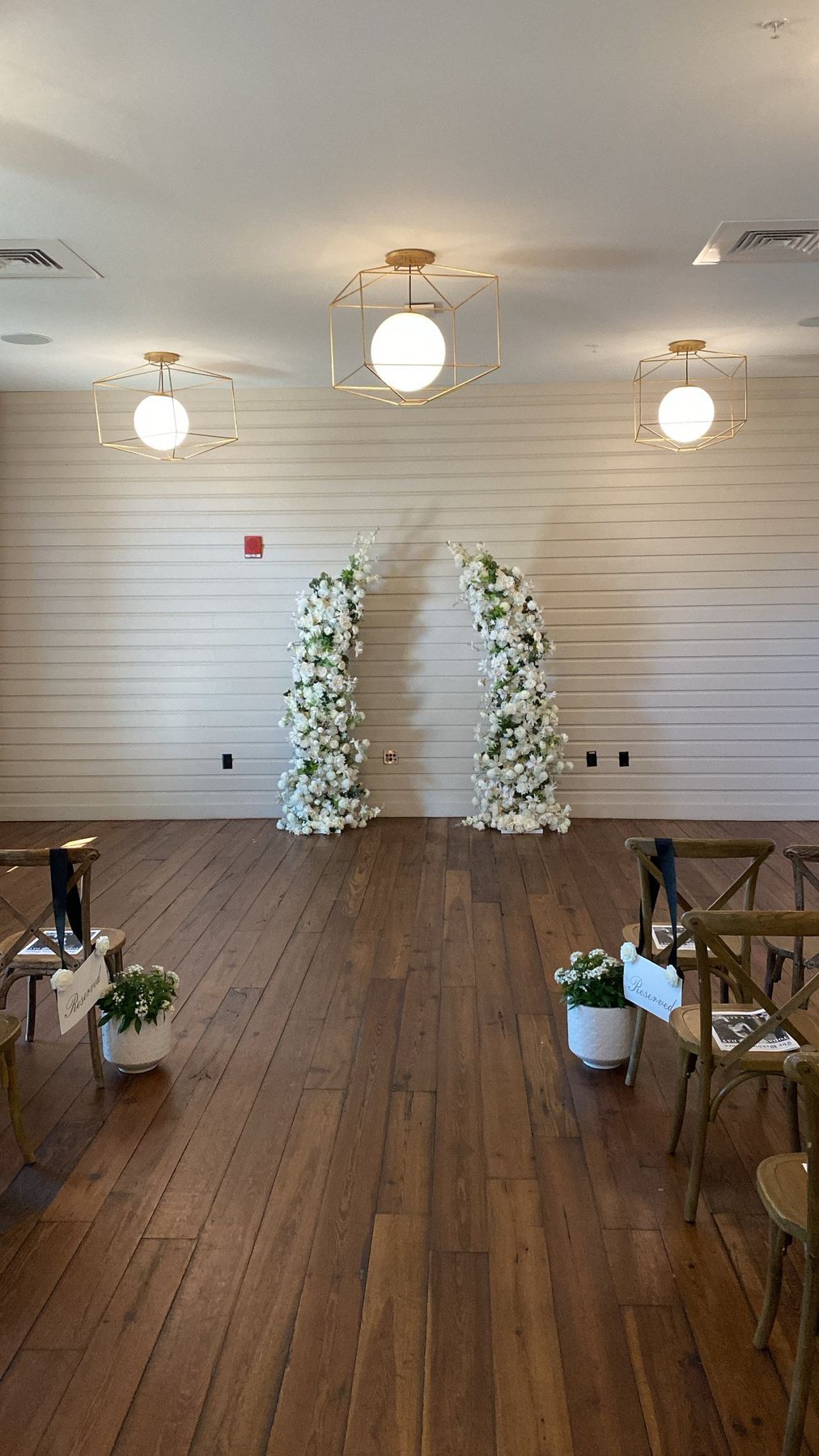 Serenity twin floral arches rental at a rustic wedding ceremony venue near Lakeland, FL