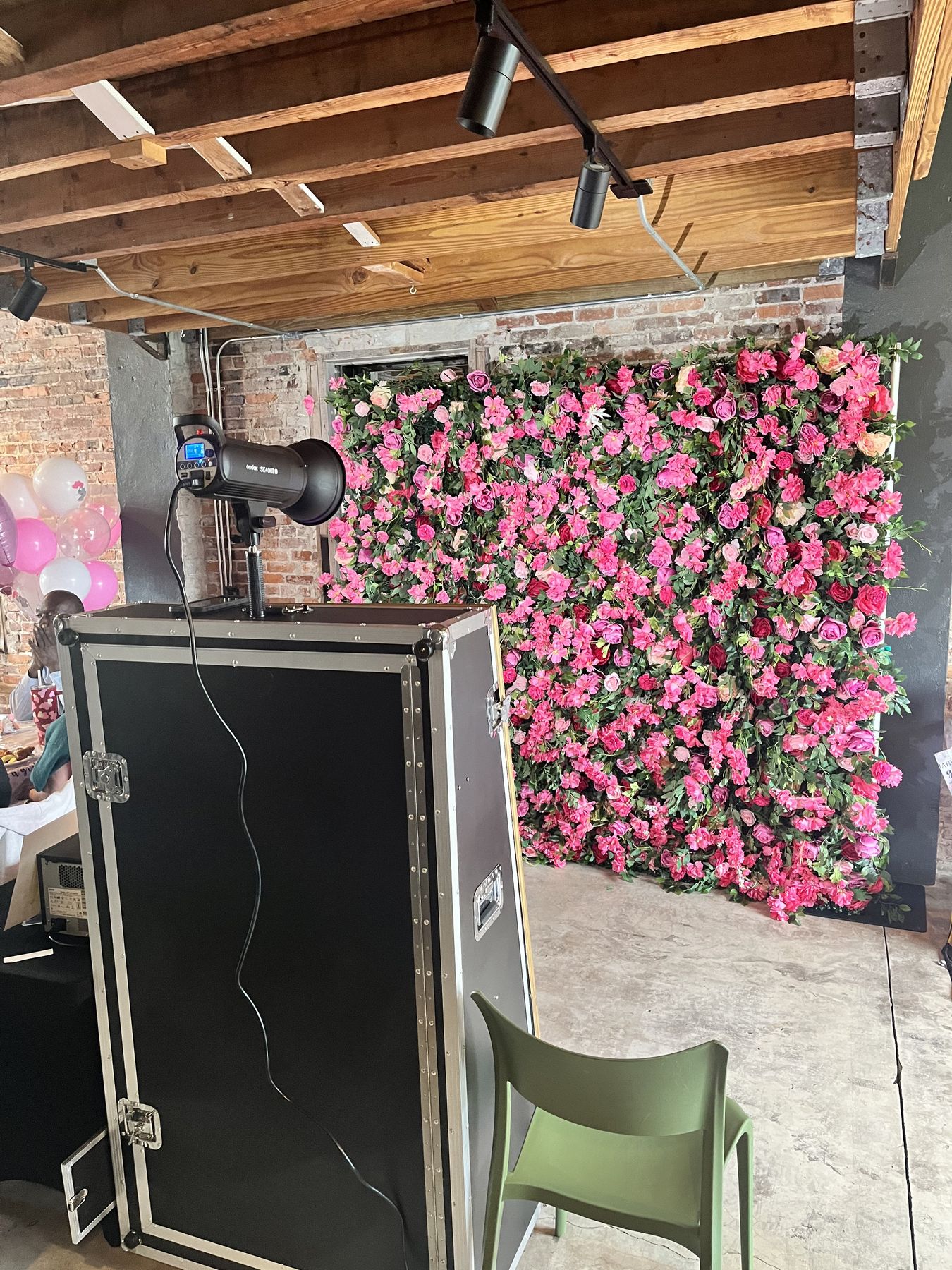Mirror photo booth with a Flora Pink flower wall backdrop at a Tampa Bay event
