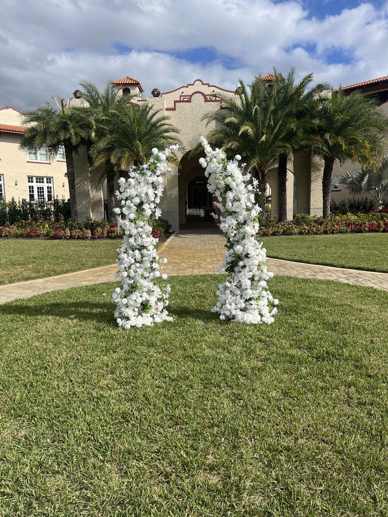 Serenity twin floral arches set for an outdoor ceremony — flower arch rental for St. Petersburg and St. Pete Beach weddings