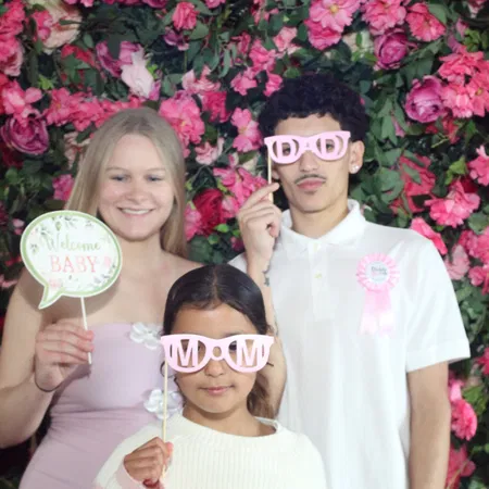 Photo booth props and accessories at a Tampa Bay baby shower with a flower wall backdrop