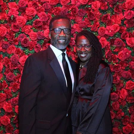 DSLR-quality mirror photo booth portrait of a couple at a Tampa Bay gala with a red rose flower wall