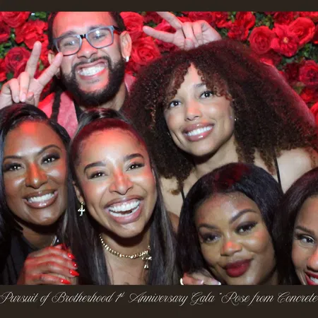 Gala group photo at the Tampa mirror photo booth with red rose flower wall
