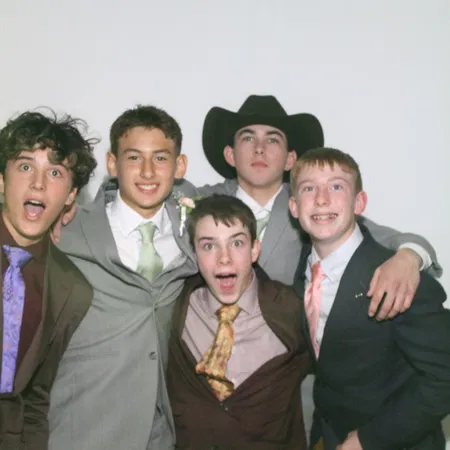 Groomsmen in suits at the mirror photo booth at a Tampa Bay wedding reception