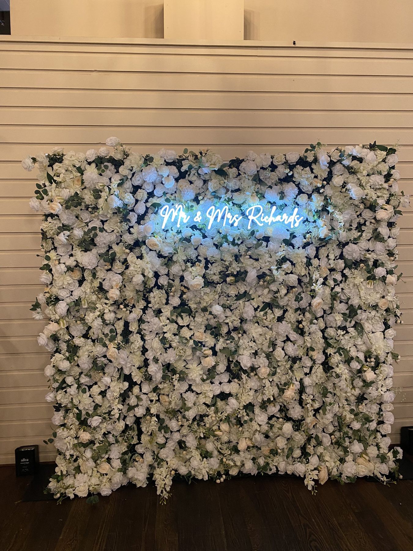 Donna Champagne flower wall with an LED sign as a reception backdrop in Tampa Bay