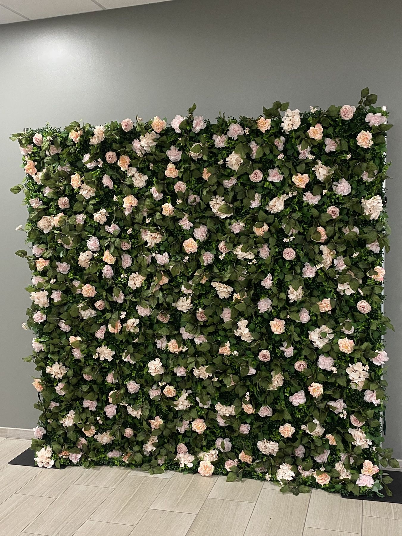 Flora Pink blush and peach rose flower wall indoors, a romantic sweetheart table idea in Tampa