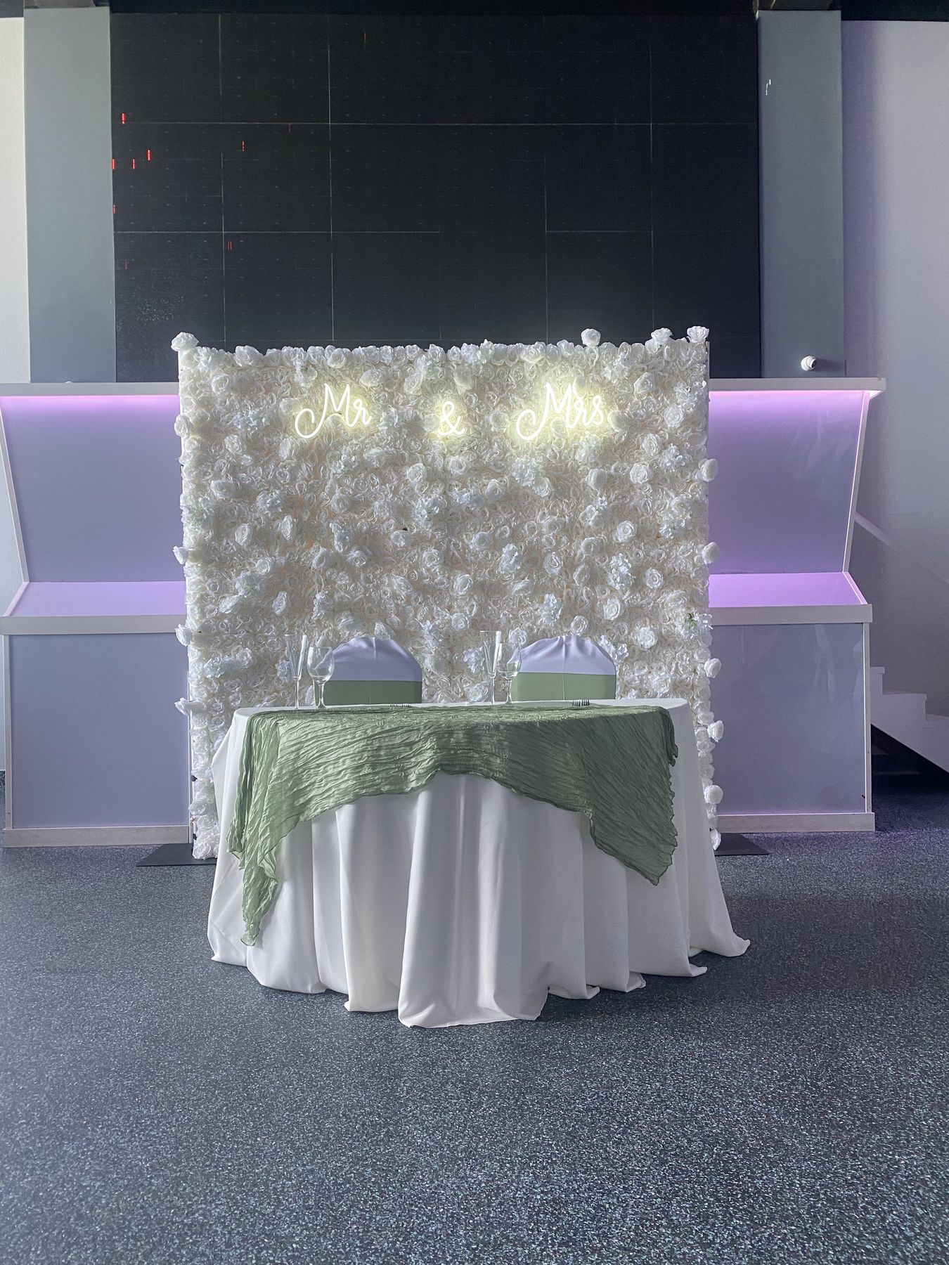 The Pearl white textured flower wall behind a sweetheart table in Tampa Bay